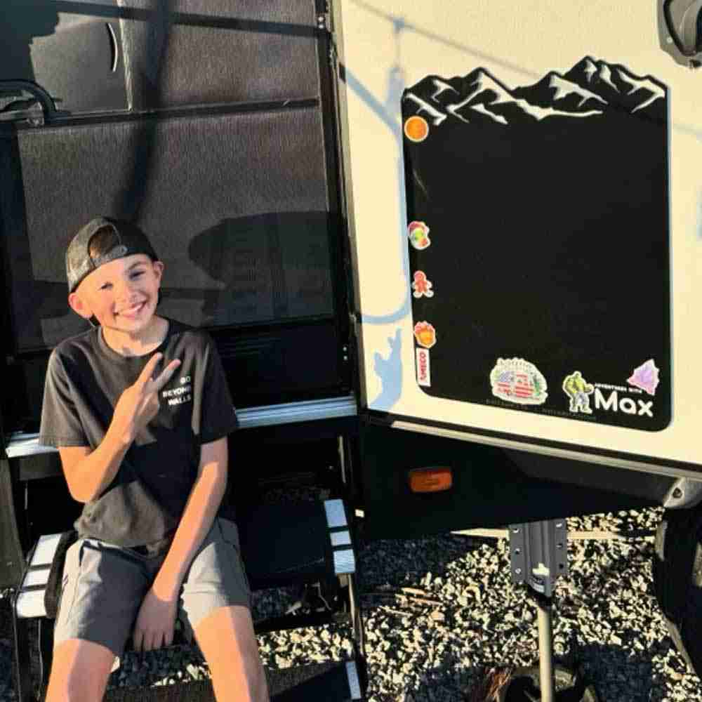 A black mountain Original Adventure board on a camper door.